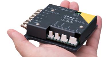 A hand with the digital delay generator 